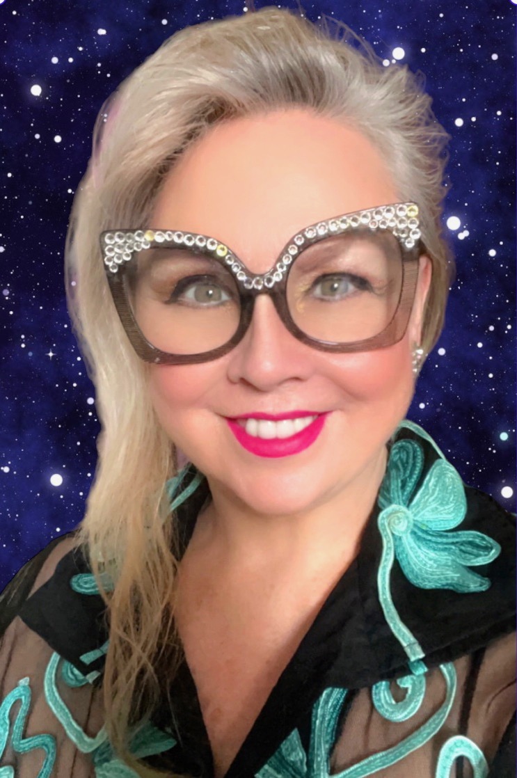 Mary Trimble portrait wearing crystal glasses with blue starry background- Marys Astrology,